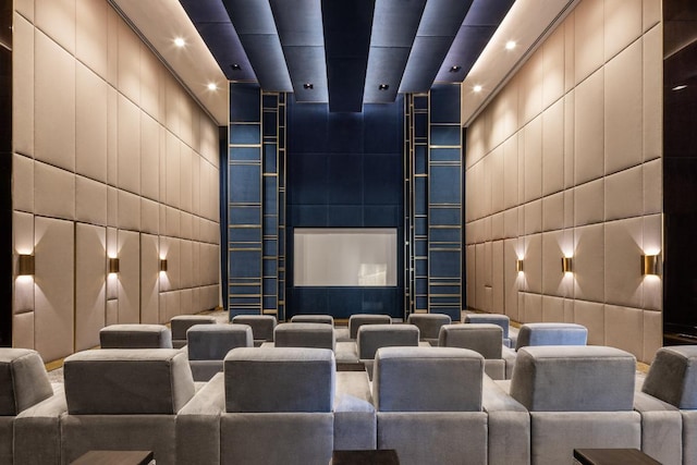 cinema room with a package area and a towering ceiling