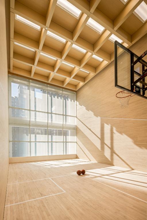 interior space with beamed ceiling, coffered ceiling, and hardwood / wood-style floors