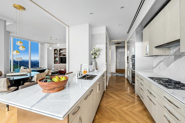 kitchen with sink, a center island, hanging light fixtures, light parquet flooring, and backsplash