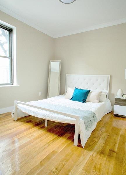 bedroom featuring crown molding and wood-type flooring