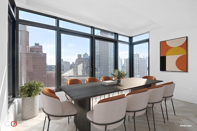 dining room featuring expansive windows and light parquet floors