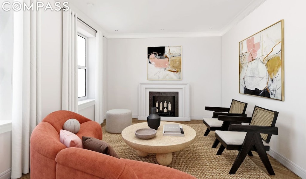 sitting room with hardwood / wood-style flooring and ornamental molding