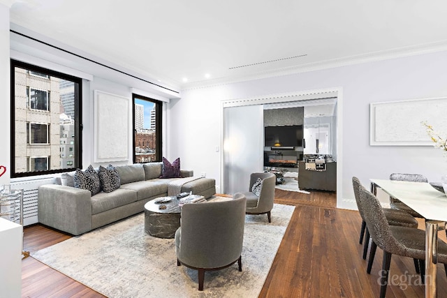 living room with crown molding and dark hardwood / wood-style flooring