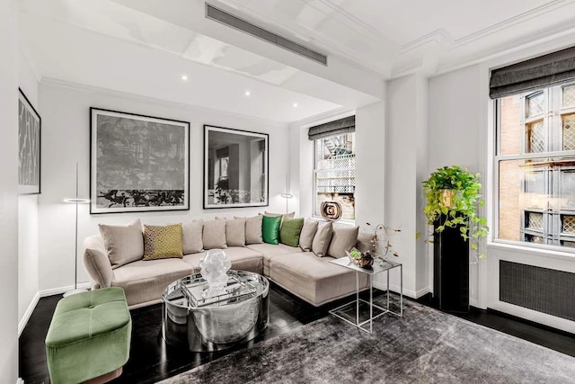 sitting room featuring ornamental molding and dark wood-type flooring