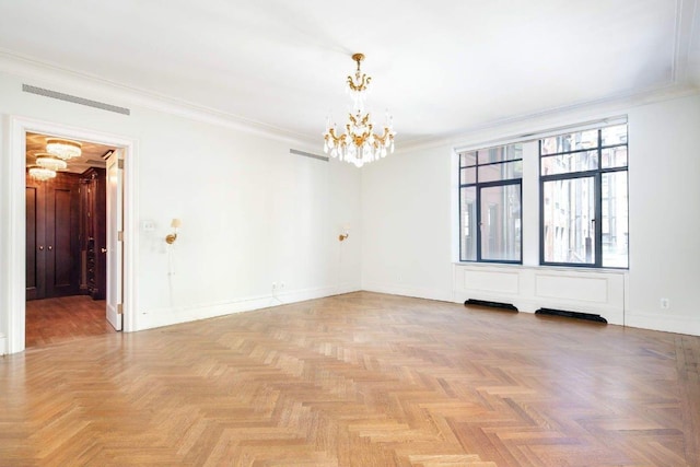 unfurnished room featuring light parquet flooring, ornamental molding, and a notable chandelier