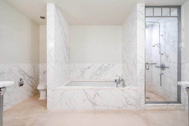 bathroom featuring toilet, tile walls, and plus walk in shower