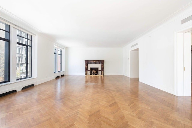 unfurnished living room featuring light parquet flooring and crown molding