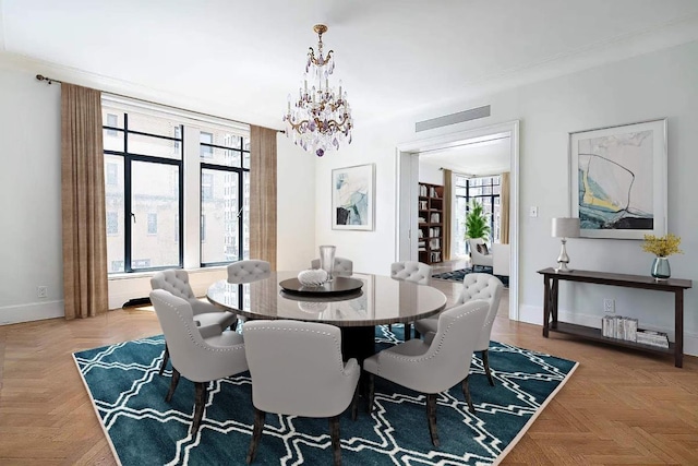 dining room featuring a chandelier and light parquet flooring