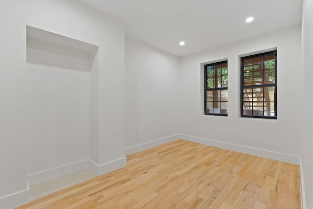 spare room with hardwood / wood-style floors