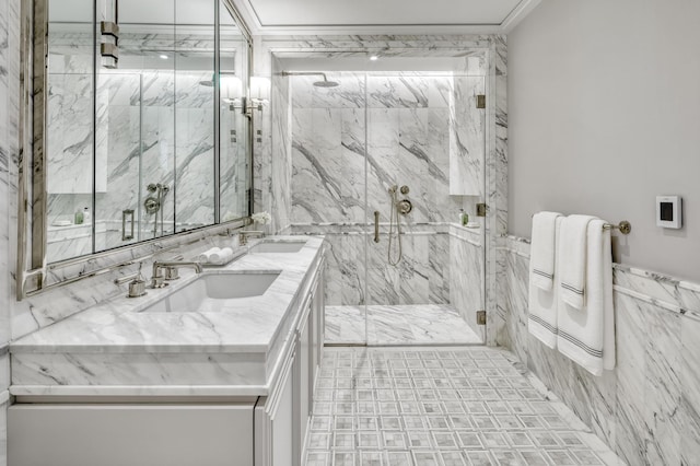 full bath with a sink, a marble finish shower, ornamental molding, and double vanity