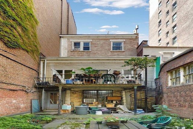 rear view of house with a balcony and a patio area