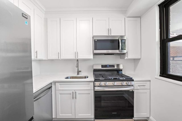 kitchen featuring sink, white cabinets, and appliances with stainless steel finishes