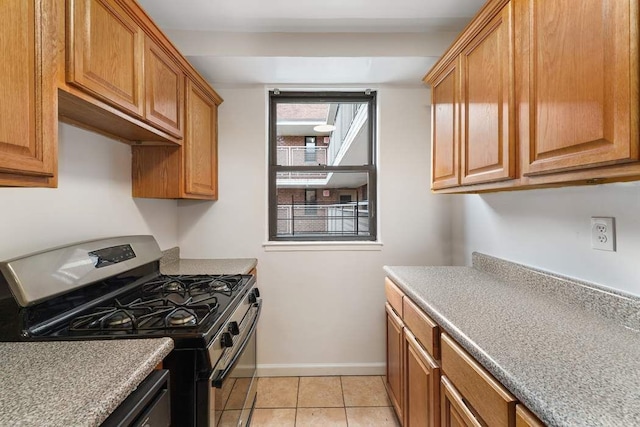 kitchen with stainless steel range with gas stovetop and light tile patterned floors