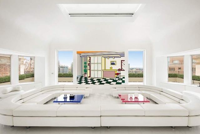 living room with a high ceiling, plenty of natural light, and a wall mounted AC