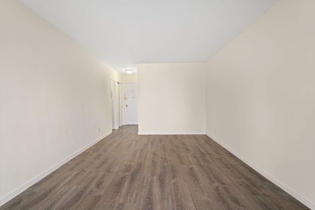 empty room featuring dark wood-type flooring