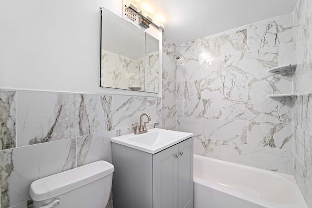 full bathroom with tiled shower / bath combo, vanity, tile walls, and toilet