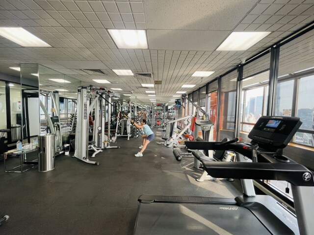 gym featuring a paneled ceiling