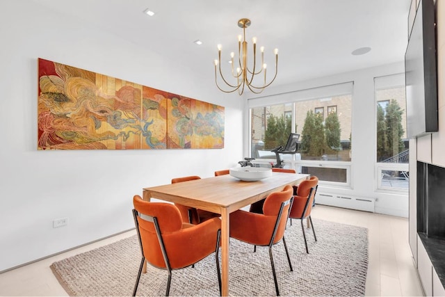 dining room with a baseboard heating unit and a chandelier