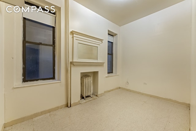 unfurnished room featuring baseboards and tile patterned floors