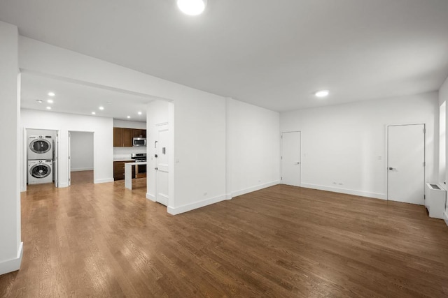 interior space featuring dark hardwood / wood-style floors and stacked washing maching and dryer