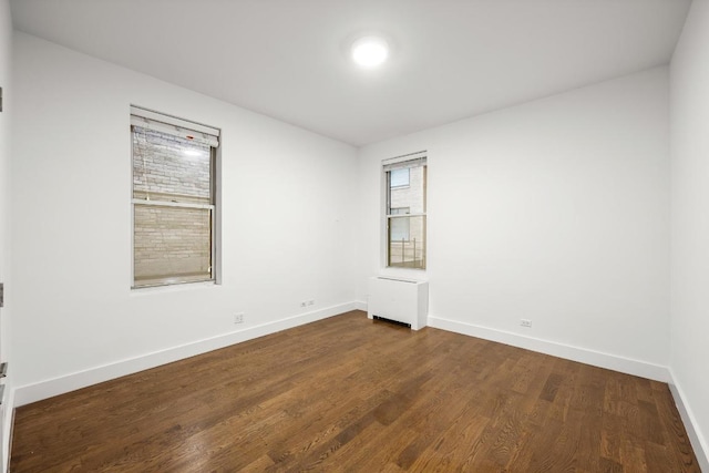 spare room with dark wood-type flooring