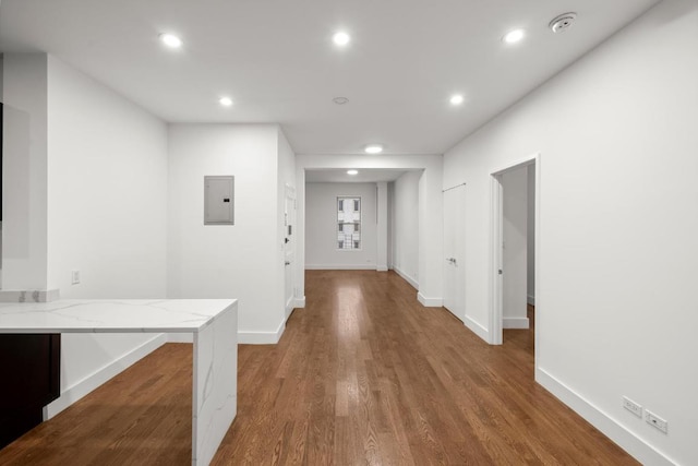 corridor featuring electric panel and hardwood / wood-style floors