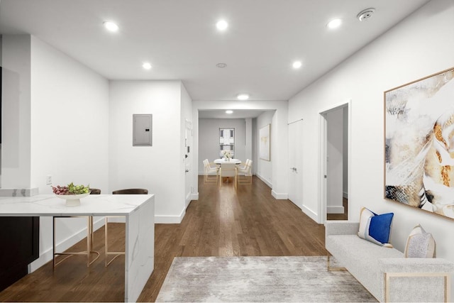 hallway with dark wood-type flooring and electric panel