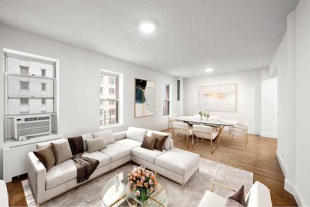 living area featuring cooling unit, baseboards, wood finished floors, and recessed lighting