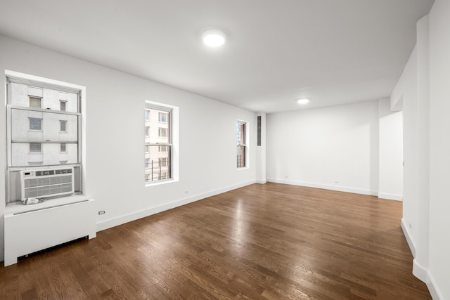 57 W 58th St Unit 6Ab, New York City, NY 10019 - unfurnished room featuring radiator heating unit, wood finished floors, and cooling unit