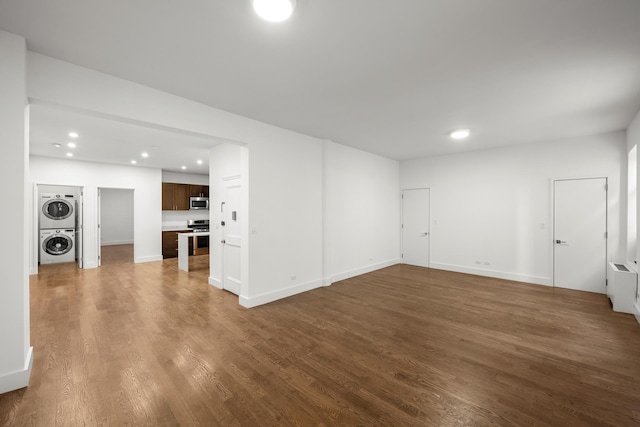 57 W 58th St Unit 6Ab, New York City, NY 10019 - unfurnished living room featuring stacked washer / dryer, dark wood-style floors, and recessed lighting