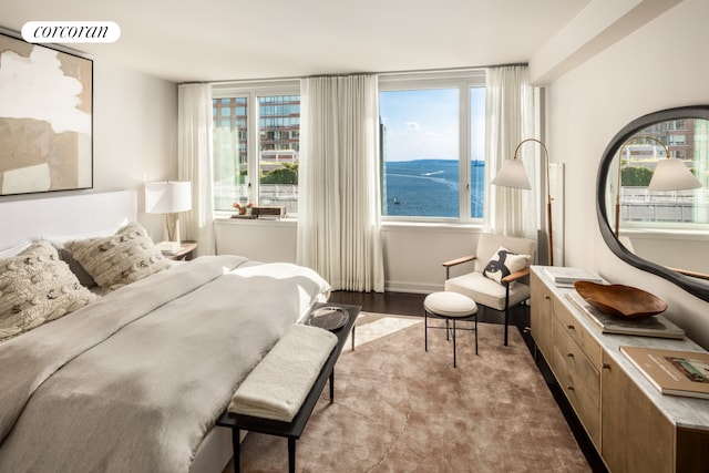 bedroom featuring visible vents, baseboards, and wood finished floors