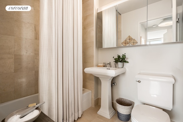 full bath with toilet, tile patterned flooring, and shower / bath combination with curtain