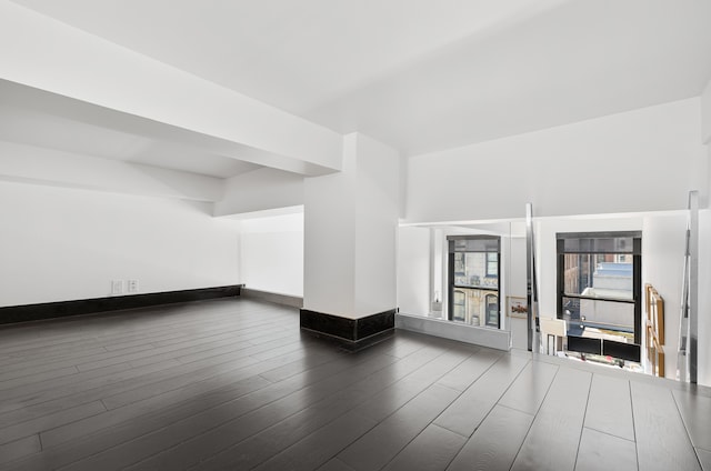 interior space with dark wood-style floors and baseboards