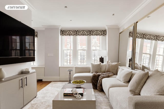 living room featuring visible vents, crown molding, light wood-style flooring, and baseboards