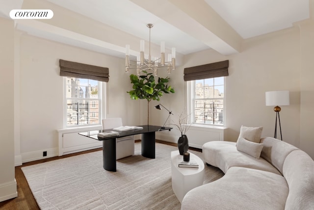 office space featuring a notable chandelier, wood finished floors, visible vents, baseboards, and beamed ceiling