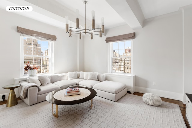 living room featuring wood-type flooring, an inviting chandelier, and beam ceiling