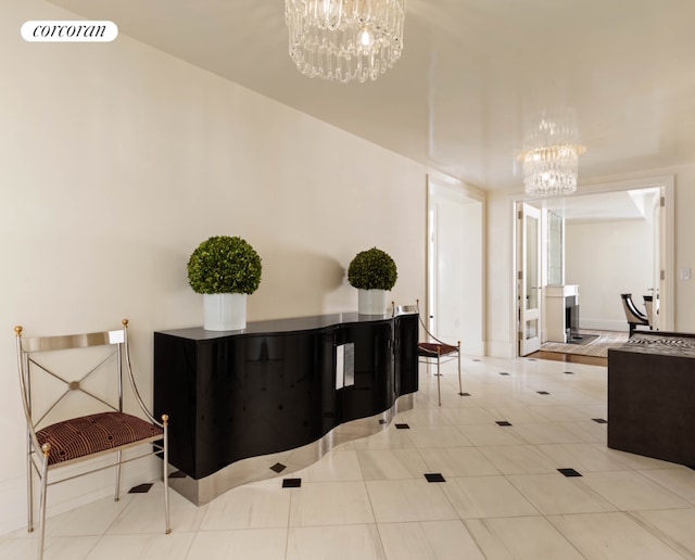 interior space featuring light tile patterned floors, visible vents, and an inviting chandelier