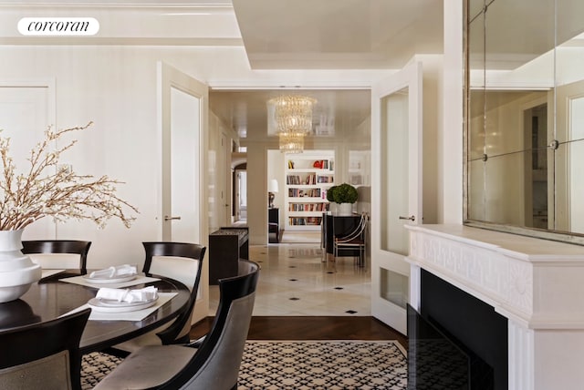 dining room with a chandelier, wood finished floors, visible vents, and built in features