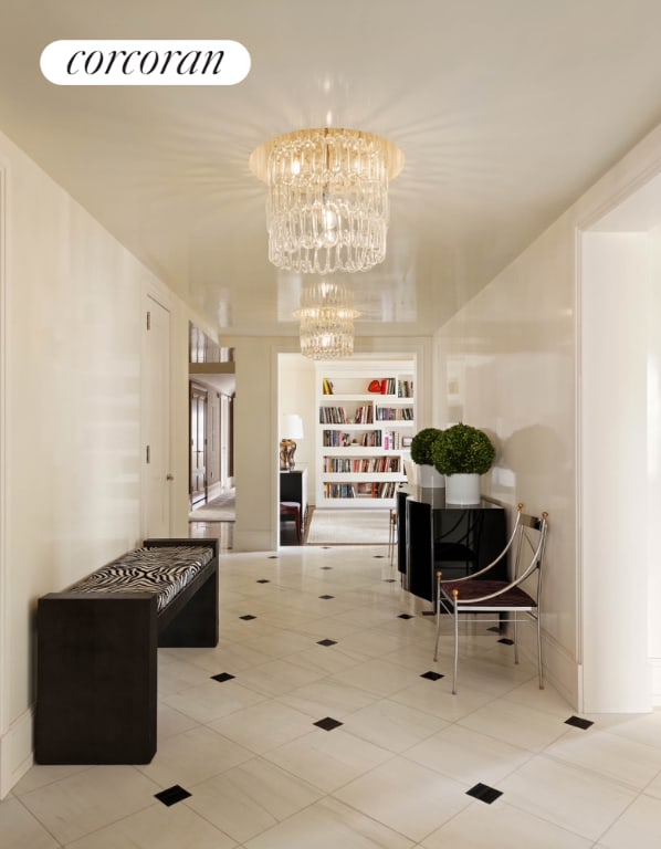 corridor with a chandelier and tile patterned flooring