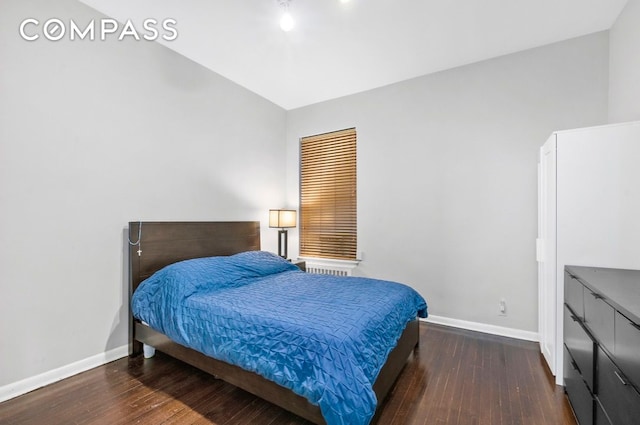 bedroom with baseboards and hardwood / wood-style floors