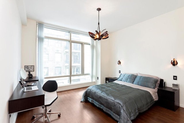 bedroom featuring dark hardwood / wood-style floors and a notable chandelier