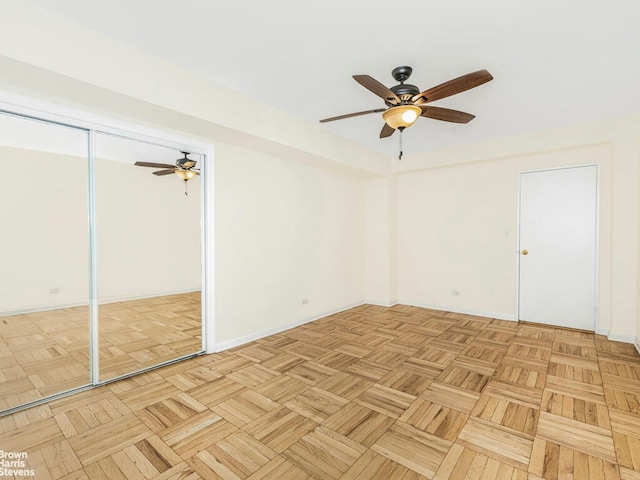 spare room featuring ceiling fan and baseboards