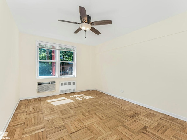 unfurnished room with baseboards, a wall unit AC, and radiator