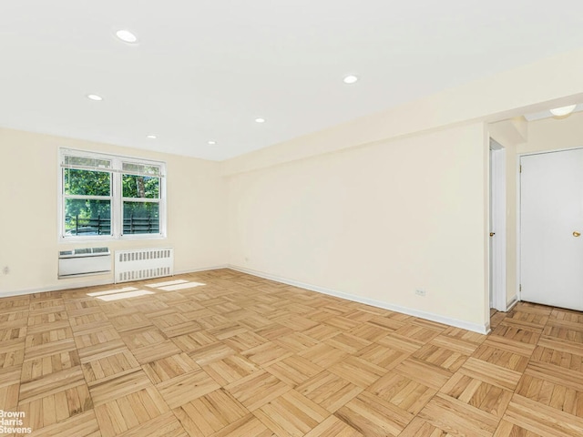 unfurnished room with radiator, baseboards, and recessed lighting