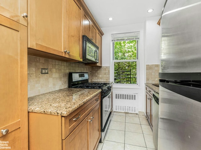 3901 Independence Ave Unit 2T, New York City, NY 10463 - kitchen featuring appliances with stainless steel finishes, radiator heating unit, tasteful backsplash, light stone countertops, and light tile patterned flooring