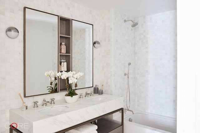 bathroom featuring vanity and tiled shower / bath