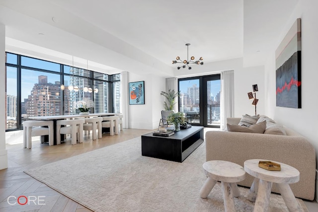 living room with light parquet flooring and a chandelier