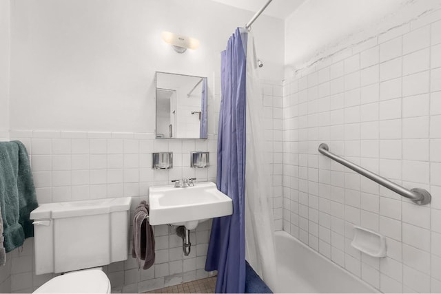 full bathroom with sink, tile walls, shower / tub combo, and toilet