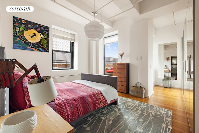 bedroom with wood finished floors and visible vents