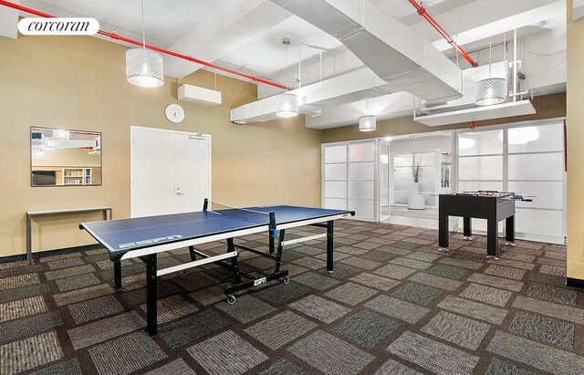 game room featuring carpet flooring, visible vents, and a towering ceiling